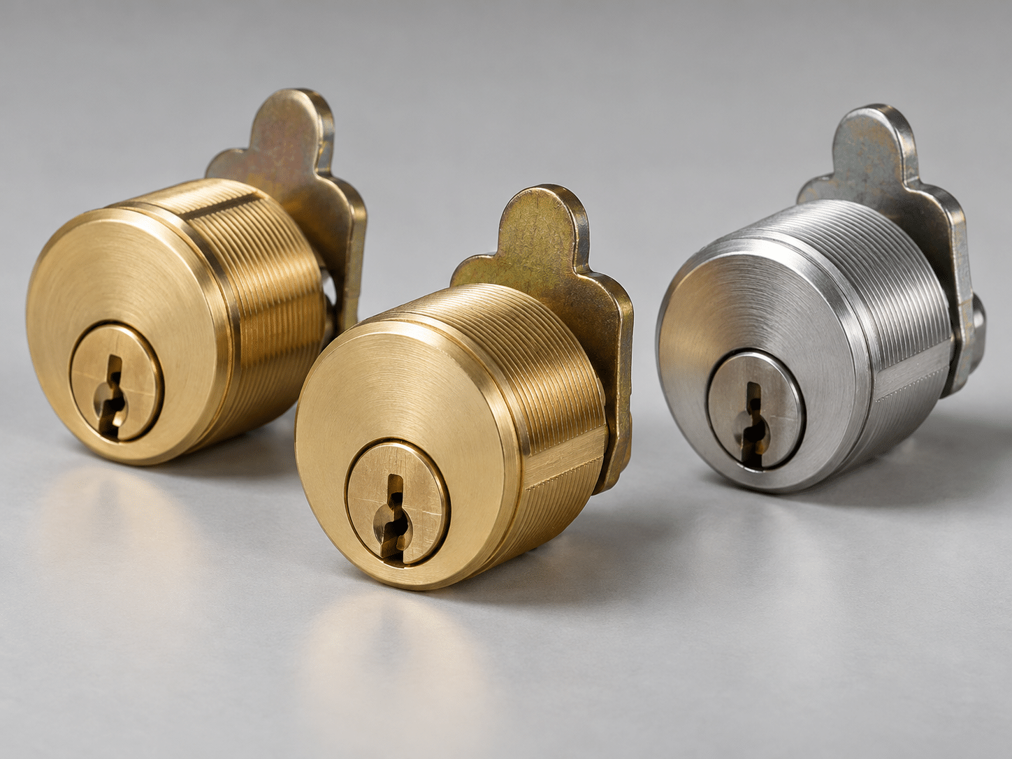 Three American-style mortise lock cylinders in brass and satin chrome